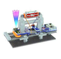 Snap Circuit Snap Bric set model showing a light beam experiment with a gray brick arch, blue & red circuits, an orange beam block, and a purple-to-blue light fiber optic filaments.