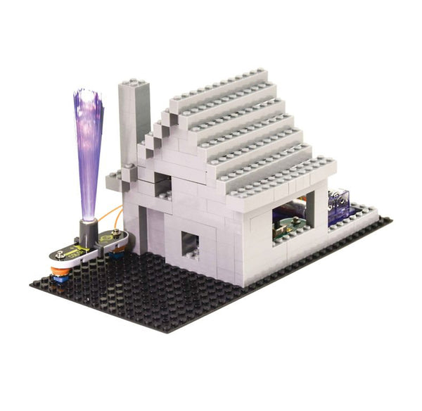 A white and gray brick-built house model with a black baseplate, a gray chimney, a purple glowing fiber optic tower on the left.
