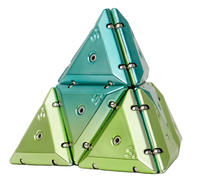 Geode chrome magnetic building triangles assembled into a pyramid, featuring translucent teal and lime green pieces with visible magnetic connectors