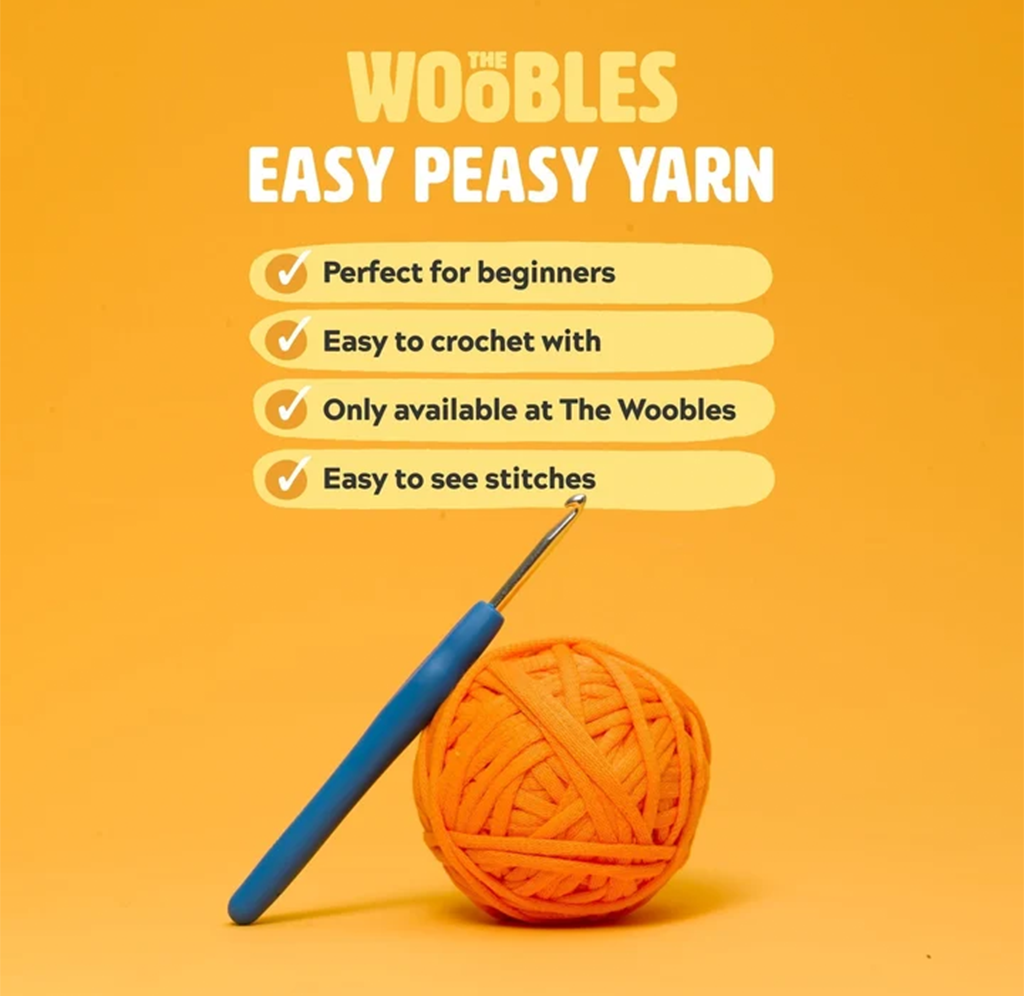 Bright orange Woobles ad features a ball of orange yarn and blue crochet hook, promoting beginner-friendly yarn with easy stitches in a cheerful tone.