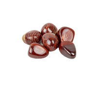 Group of polished red stones on a white background