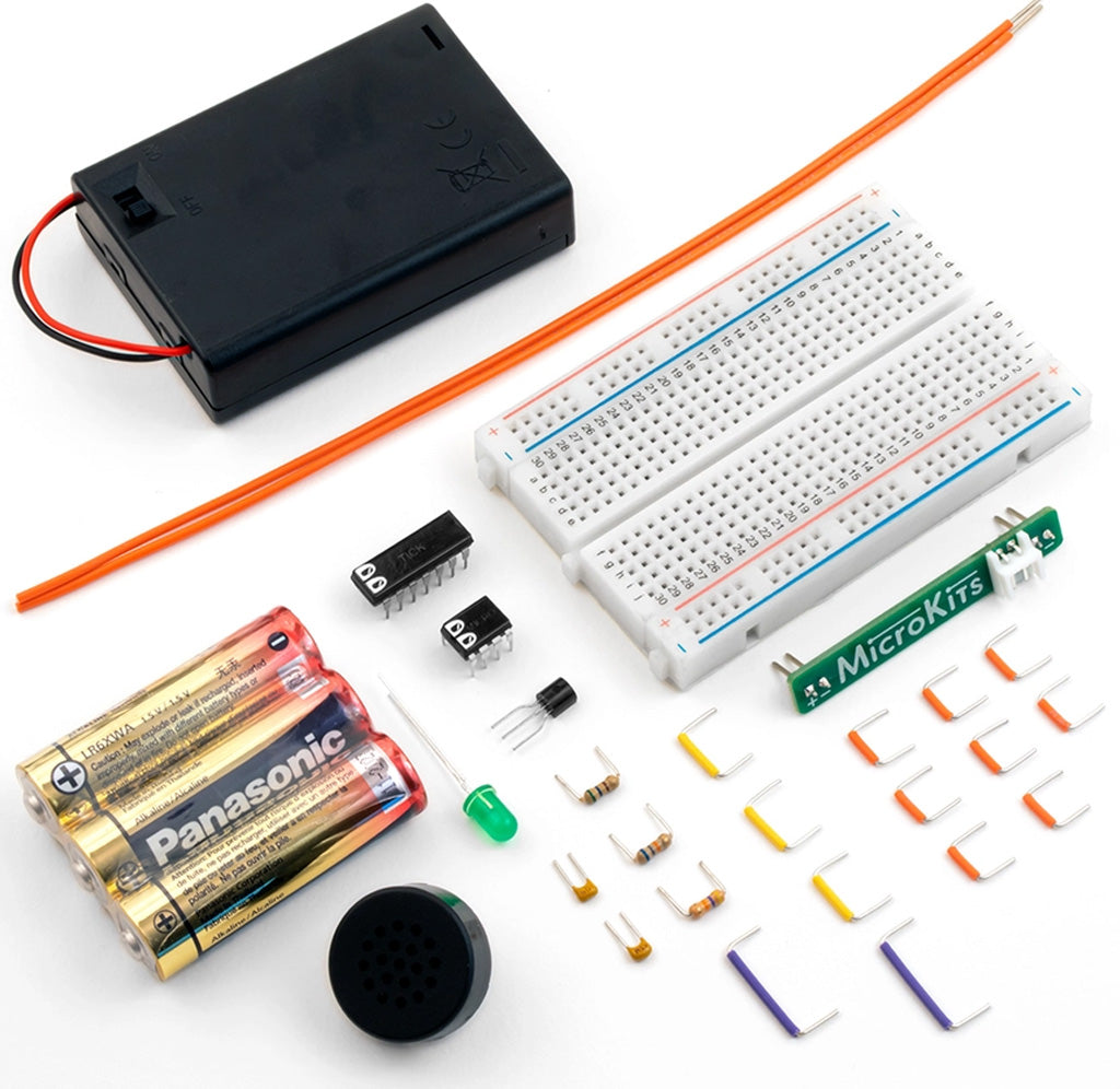 Electronics components including a breadboard, batteries, and resistors on a white background