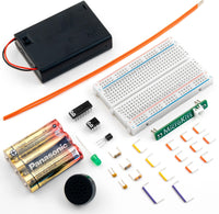 Electronics components including a breadboard, batteries, and resistors on a white background