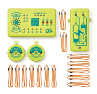 Overhead view of a bright yellow-green electronics experiment kit, with labeled circuit modules, two round test units, and neatly arranged orange wires on a white background.