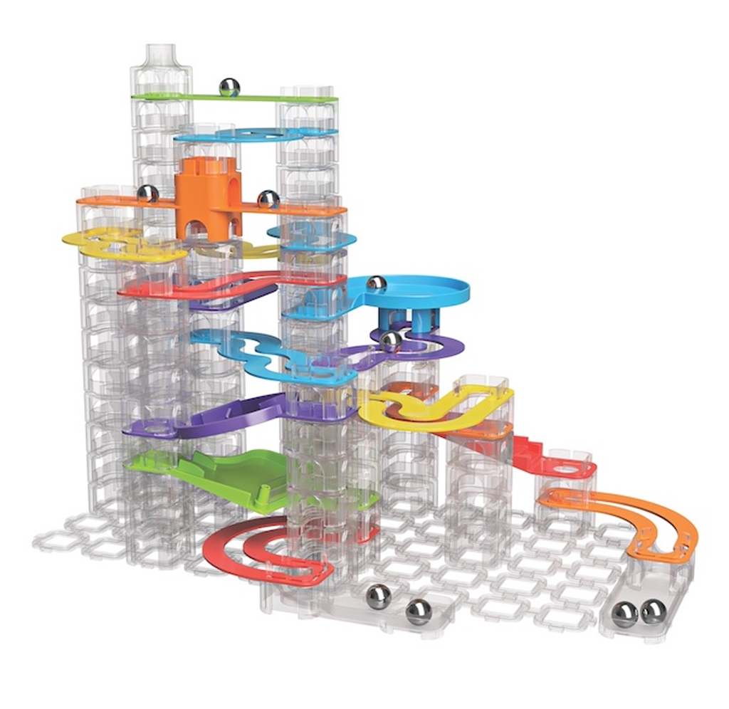 Image of the Trestle Tracks builder set assembled in one configuration with all the pieces. There are clear blocks, solid colored curved plastic pieces, and silver marbles along the track. 