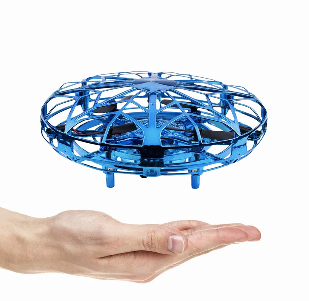 A blue toy hovering above an outstretched hand. 