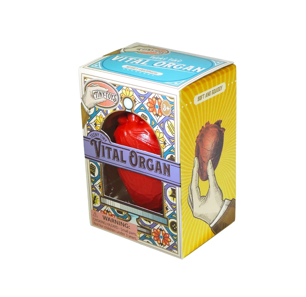 Vintage-style “Vital Organ” toy box with a red anatomical heart inside, colorful art, warning label, and illustrated hand holding a heart.