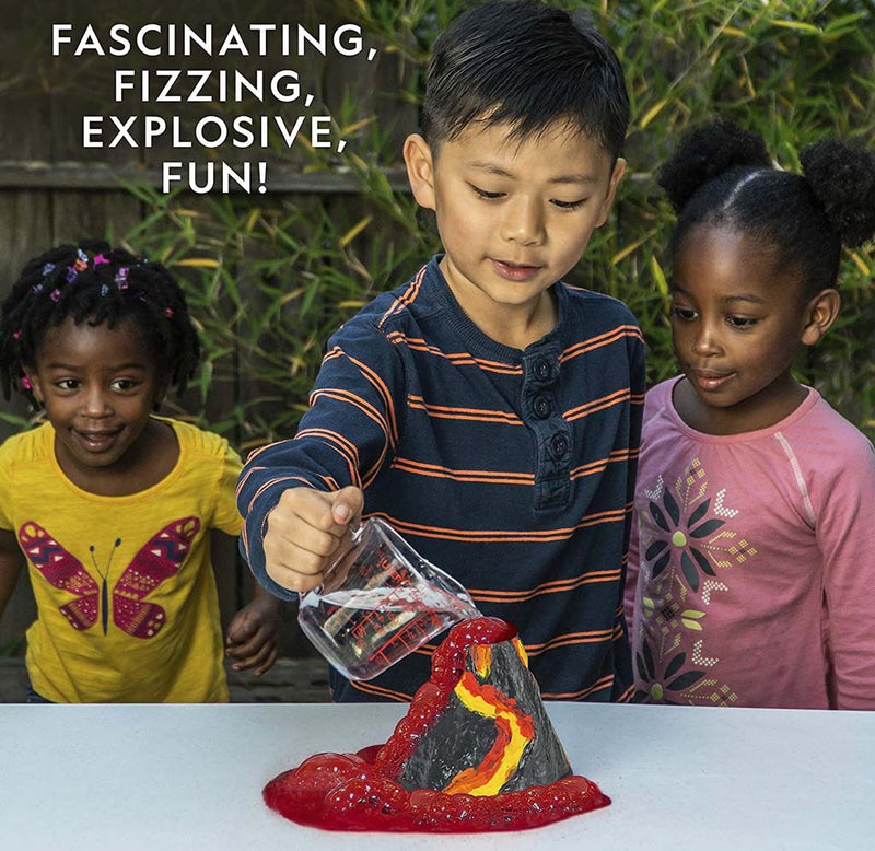 Children conducting a science experiment with a volcano model outdoors.