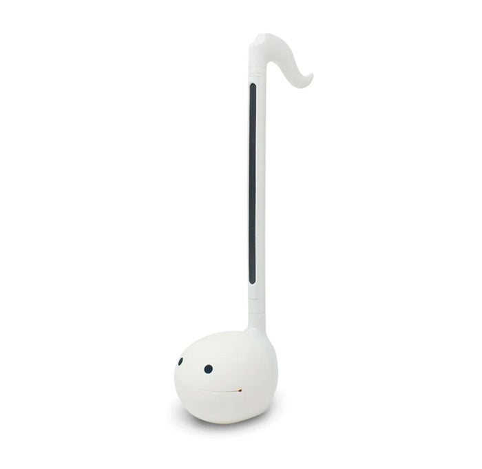 A long slender white musical instrument that is in the shape of an eight note with black eyes on the base.