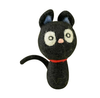A black felt cat figurine with white eyes, a pink nose, blue inner ears, and a red collar, shown against a plain white background.