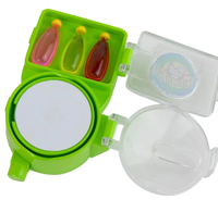 Bright green toy makeup compact opens to reveal a round mirror and three colorful bottle-shaped pieces, with a translucent lid, creating a playful, child-friendly feel.