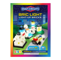 Snap Circuits Light-Up Bricks packaging with colorful design and toy bricks on a cityscape background.