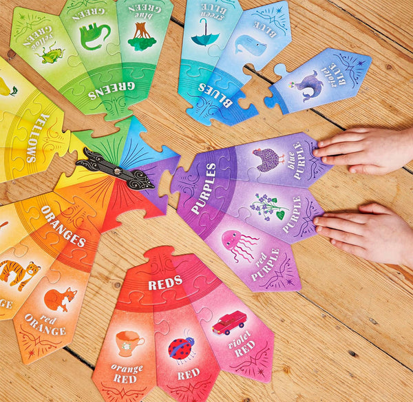 Colorful children's puzzle with pieces labeled for each color on a wooden surface.