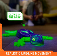 Toy gecko with glowing features on a wooden floor, child in the background