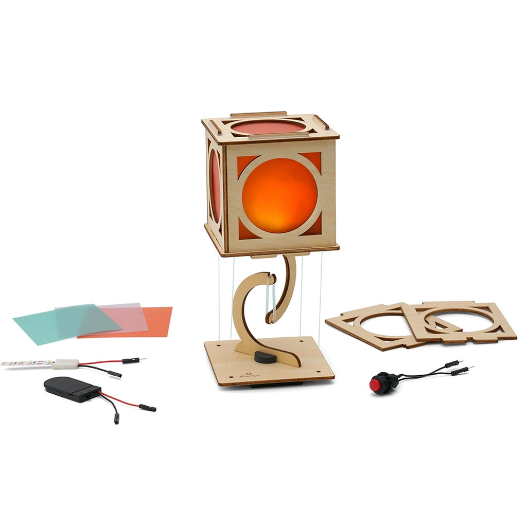 Wooden lantern with orange panes and pieces around it. 