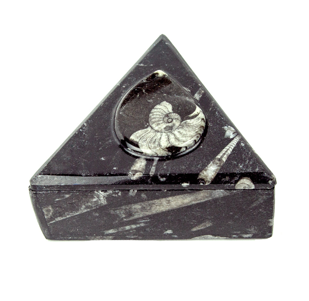 Triangular black marble box with a carved spiral design on the lid.