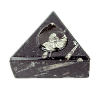 Triangular black marble box with a carved spiral design on the lid.