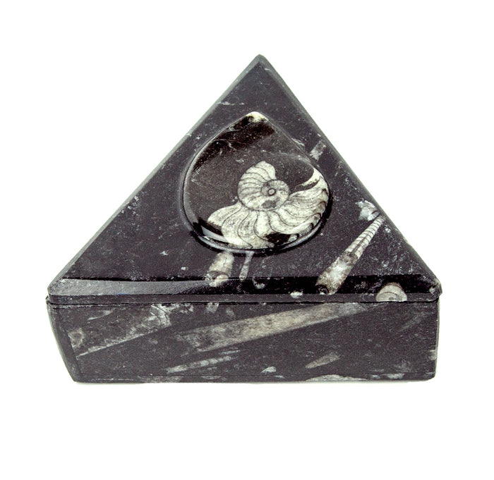 Triangular black marble box with a carved spiral design on the lid.