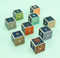 Set of wooden cubes with planetary designs on a light green background