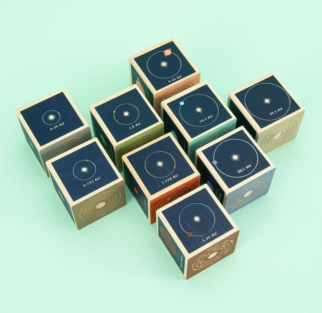 Wooden blocks with solar system design on a light green background