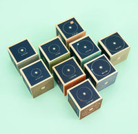 Wooden blocks with solar system design on a light green background