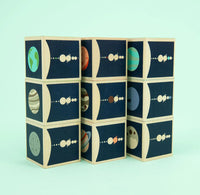 Stack of blocks with planet illustrations on a light blue background