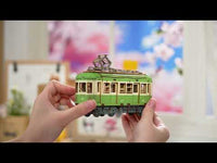 Video of hands assembling a tram kit. 