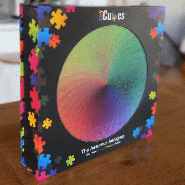 A video showing a lenticular rainbow circle on a black buzzle box. 