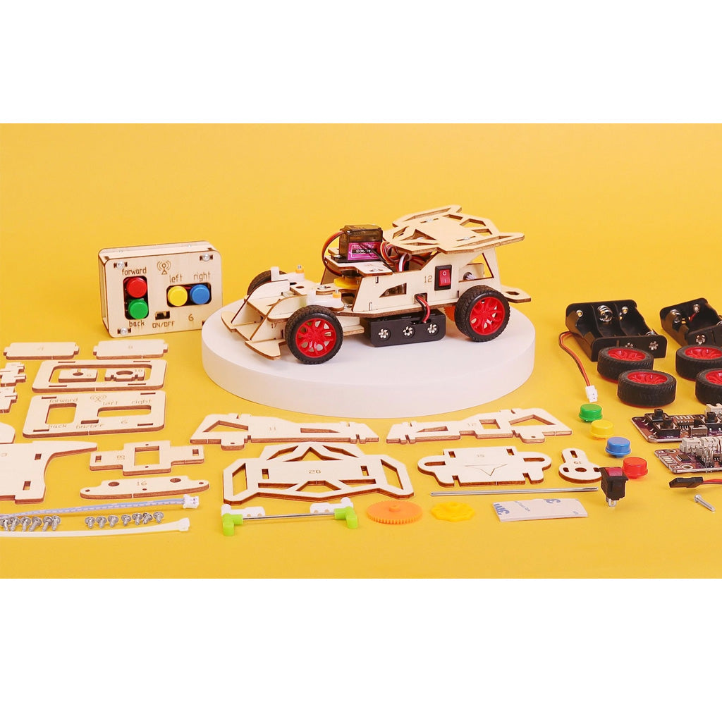 Educational DIY car kit with wooden components and electronic parts on a yellow background