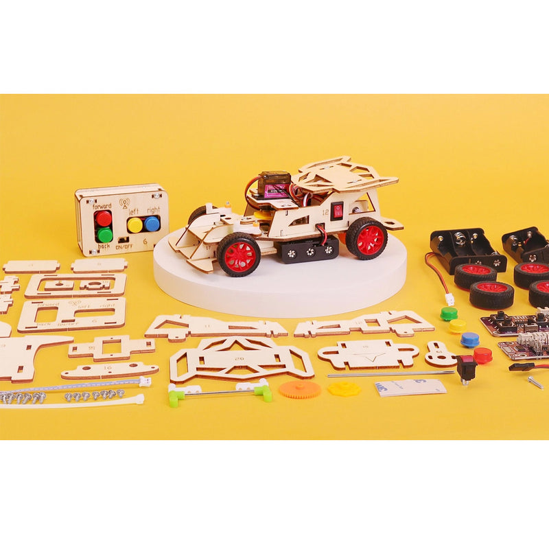 Educational DIY car kit with wooden components and electronic parts on a yellow background