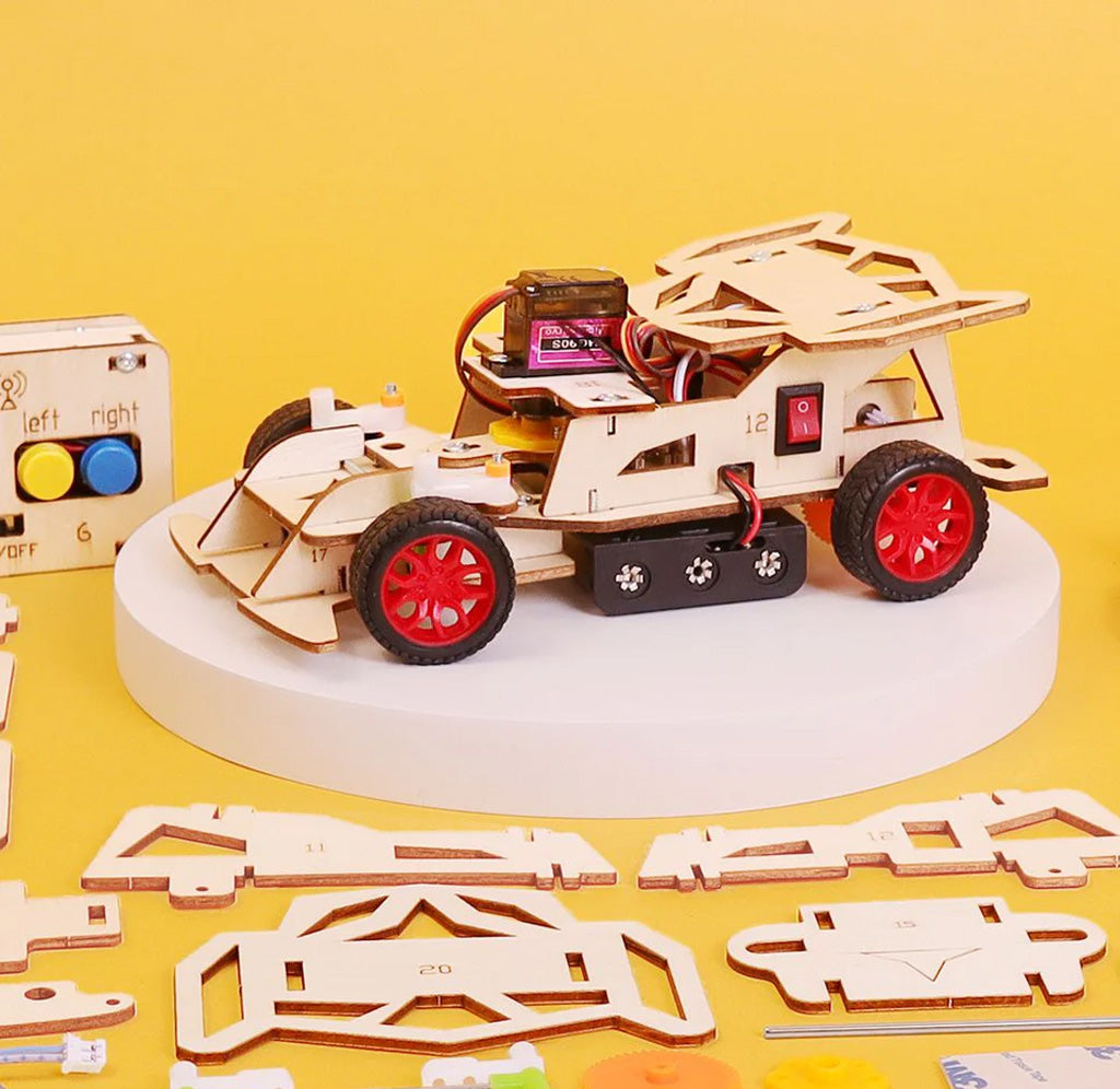 Wooden car kit with red wheels on a yellow background