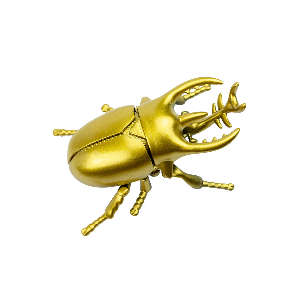 Gold rhinoceros beetle toy on a white background