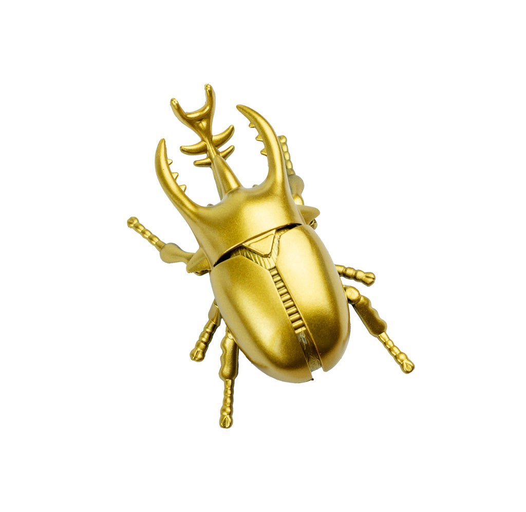 Gold rhinoceros beetle toy on a white background