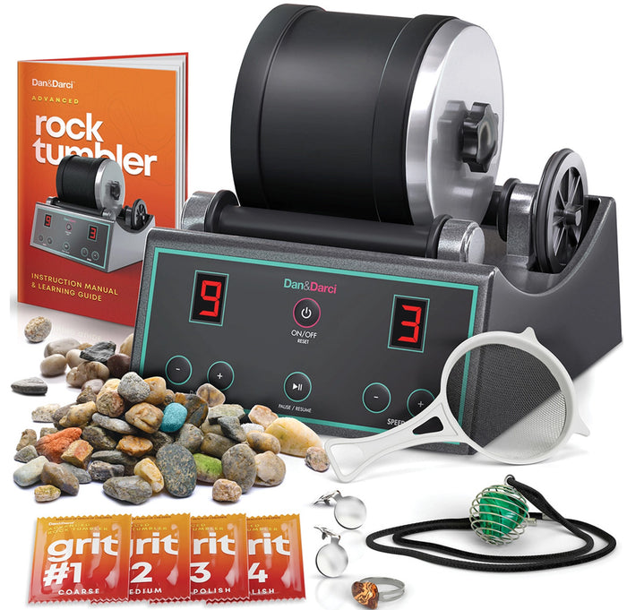 Rock tumbler with accessories and instruction manual on a white background