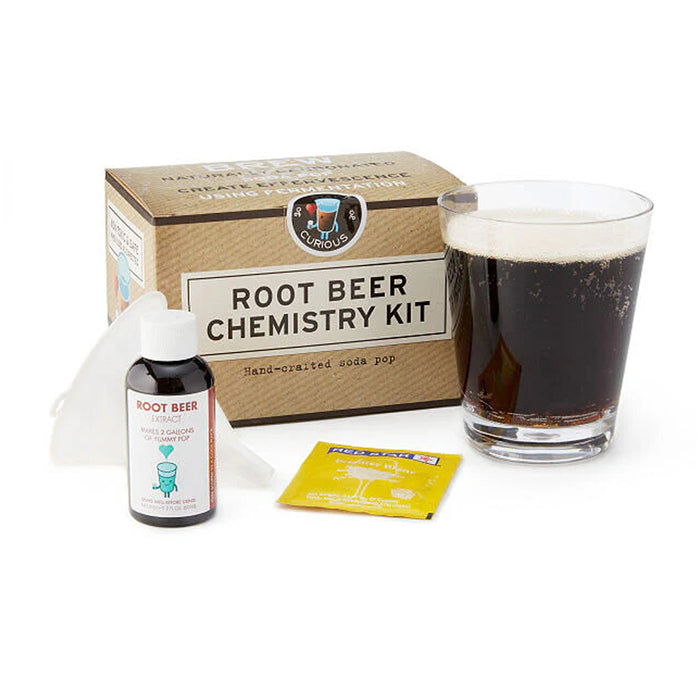 Root beer chemistry kit with a glass of root beer, funnel, packet, and bottle on a white background