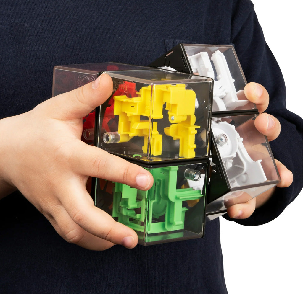 Transparent cube toy with yellow and green mechanical parts held by a person