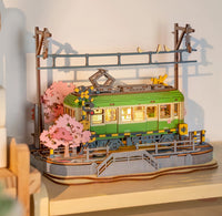 Model of a tram with cherry blossom trees on a shelf