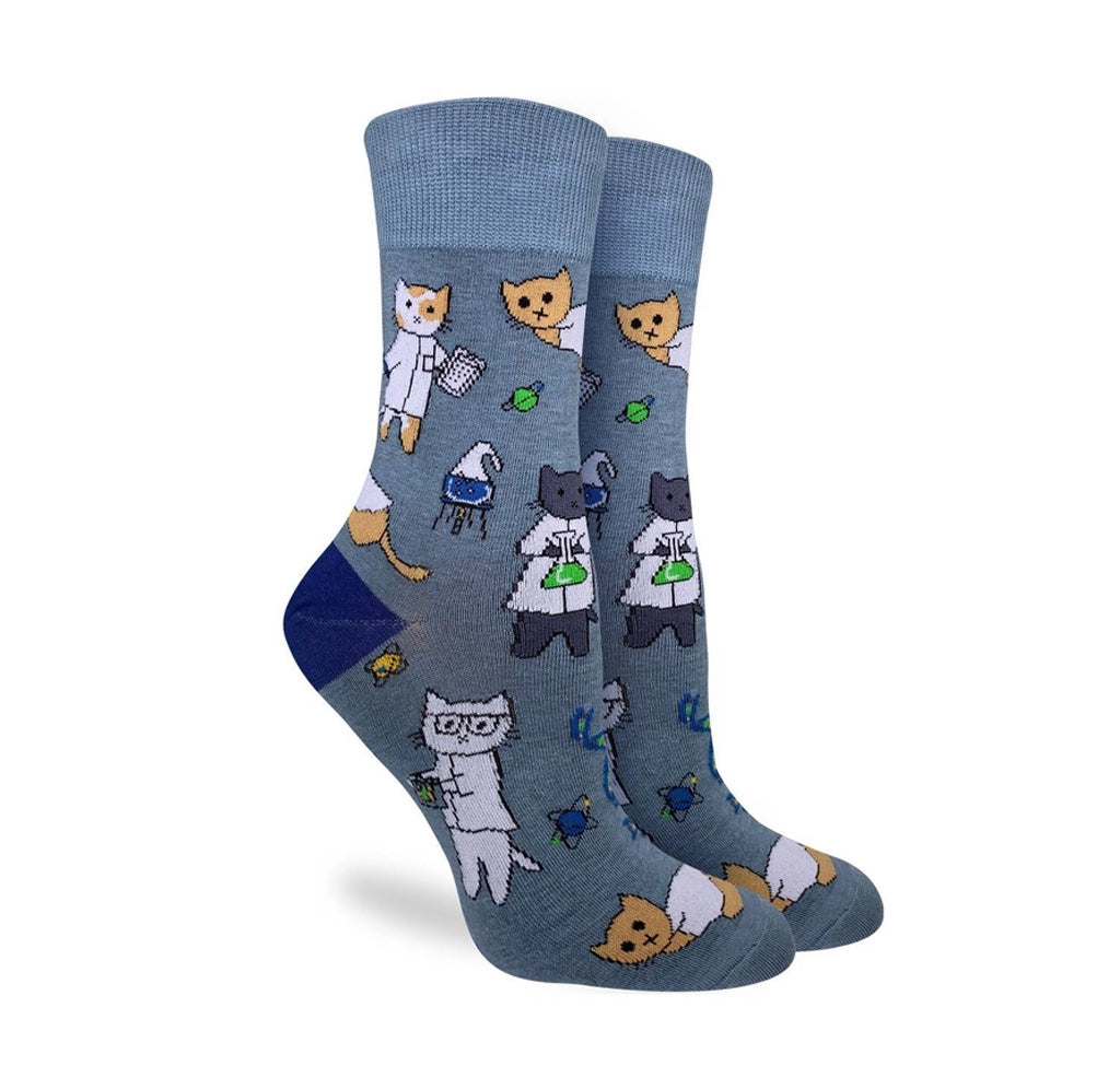Blue socks with various cats in white lab coats and beakers printed on it. 
