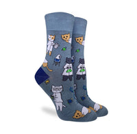 Blue socks with various cats in white lab coats and beakers printed on it. 