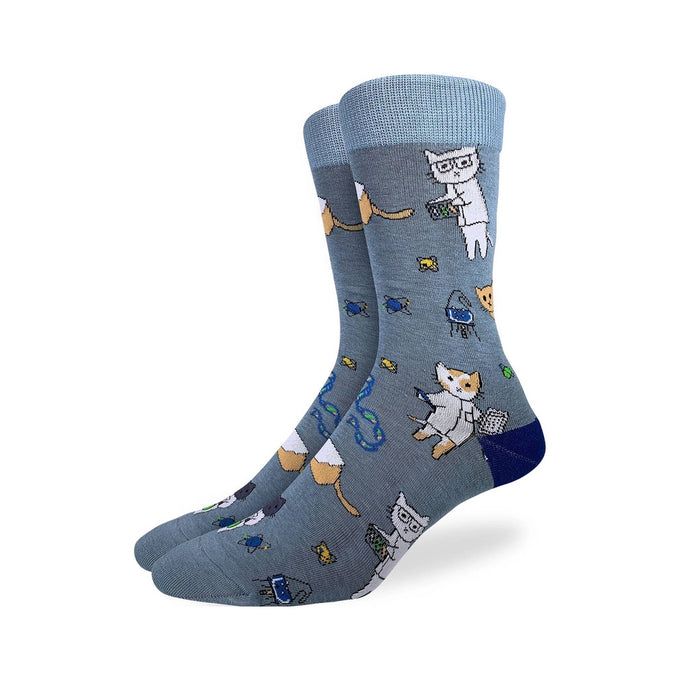 Blue socks with various cats in white lab coats and beakers printed on it. 