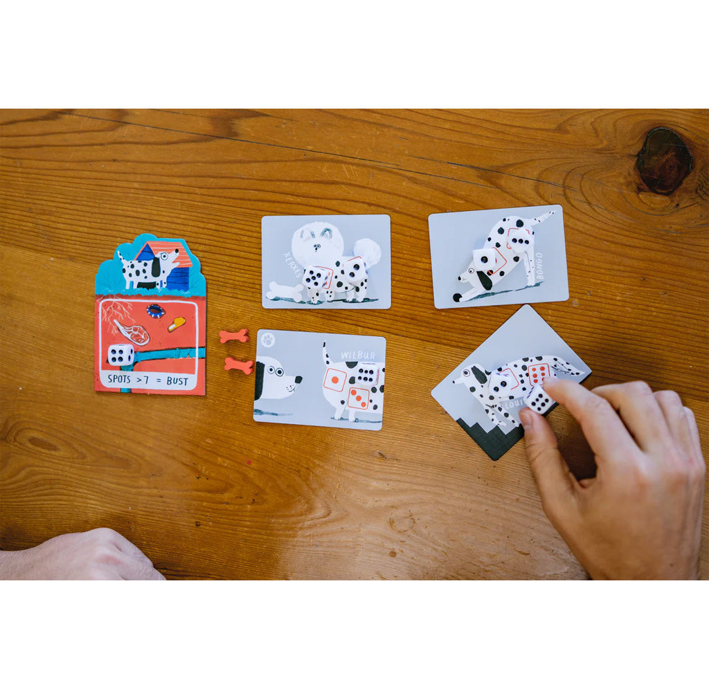 Card game with animal cards and dice on a wooden table