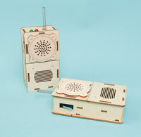 Two wooden toy walkie talkies on a light blue background