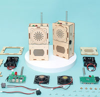 Wooden electronic project kit with components on a blue background