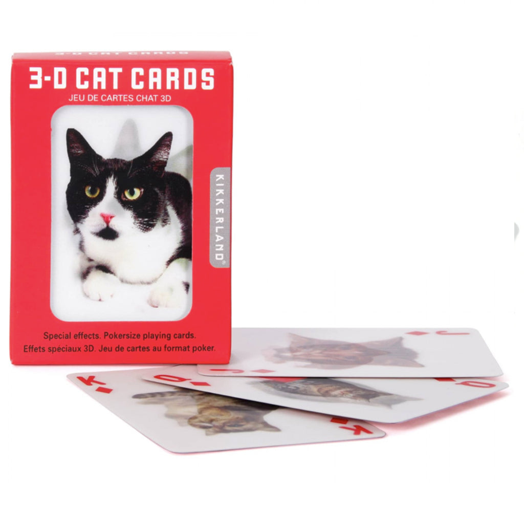 Red and white box with a window to see lenticular black and white cat image on playing cards. Four playing cards with different lenticular cat images lying in front of the playing cards box.