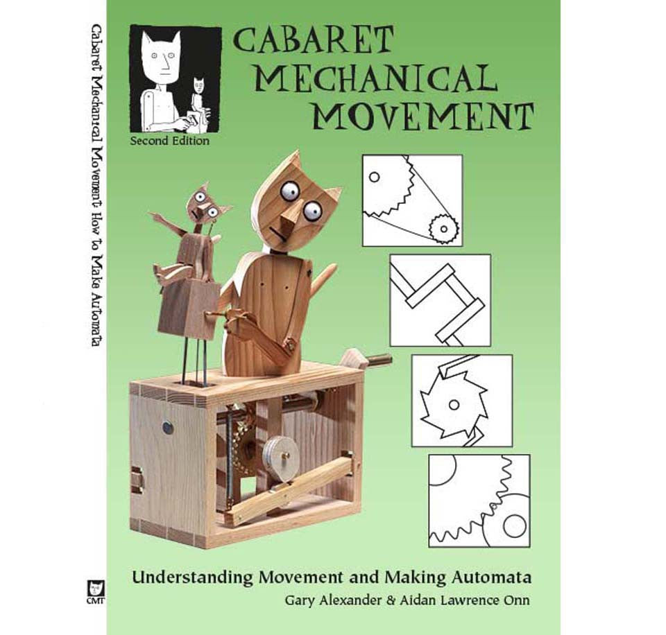 A  green paperback book with  an Automata made of a cat moving its own Automata of a cat. There are drawings of the gear mechanisms along the side. 