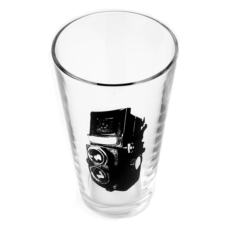 This is an image of a 16oz pint glass with a twin-lens reflex camera in black ink.