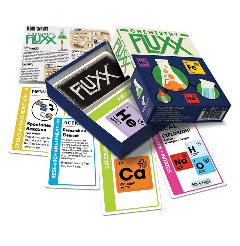 The Chemistry Fluxx game box is sitting on top of the game cards. The cards have periodic elements on them with keepers. goals. rules and actions. 