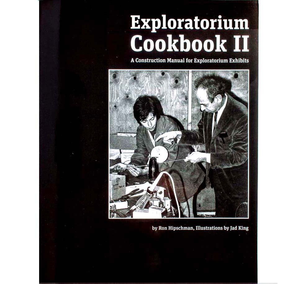 This softcover book is black with an image of Frank Oppenheimer and a young man working on an Exploratorium exhibit.