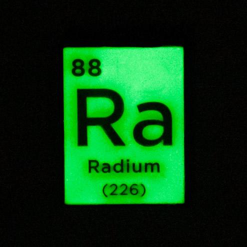 A green periodic table square for radium with black writing. It glows in the dark, similar to what radium would look like.