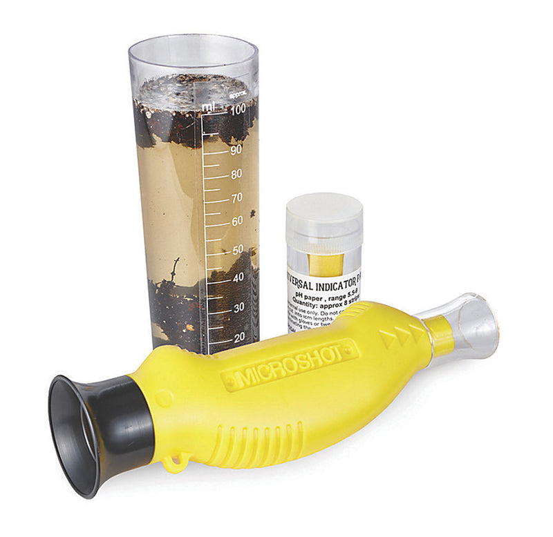 There is a graduated cylinder with soil and water in it, PH papers for testing, and a small handheld microscope.